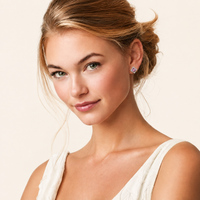Model wearing Pink Moissanite Diamond Halo Studs with round pink center stones and sparkling sterling silver halos | Olaty