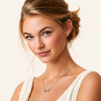 Woman wearing pink moissanite diamond LOVE necklace in polished 925 sterling silver | Olaty