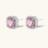 Angled pair of pink moissanite halo studs showing sterling silver settings and posts | Olaty