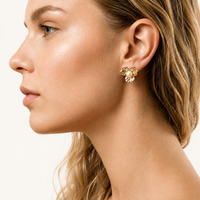 Gold floral pearl stud earring worn on model side profile | Olaty