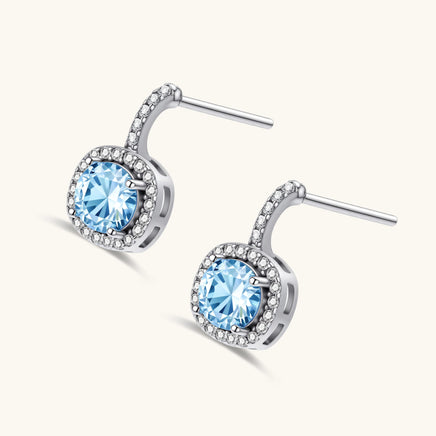 GRA certified blue moissanite diamond celestial halo drop earrings in angled product view | Olaty