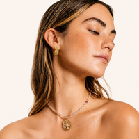 Bloom Filigree gold floral hoop earring with intricate dimensional filigree design worn on model | Olaty