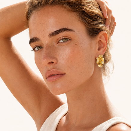 Bloom double floral statement earrings styled on model showing dimensional gold flower design | Olaty