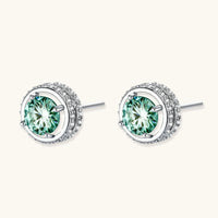 Angled view of Green Moissanite Diamond Emerald Spark Halo Stud Earrings with sparkling halo setting | Olaty