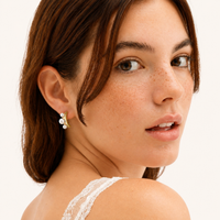 Pearl Trio Curve stud earring with three freshwater pearls and sculptural gold curve worn on model | Olaty