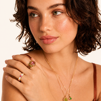 Love + Logic adjustable gold ring with red heart and clear baguette zirconia styled on model | Olaty