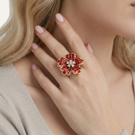 Close-up of model wearing crimson bloom statement ring with red and clear zirconia flower design | Olaty