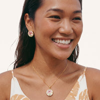Model wearing round pink rose floral pendant necklace with delicate gold chain | Olaty