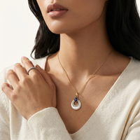 Close-up model wearing blue lapis lazuli and mother of pearl pendant necklace | Olaty