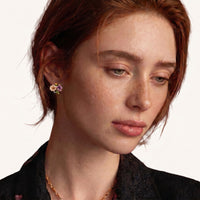 Model wearing colorful wildflower stud earring with white and purple enamel flowers | Olaty