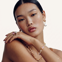 Model wearing statement ring with pink crystal, amber stone and sparkling pavé sphere | Olaty