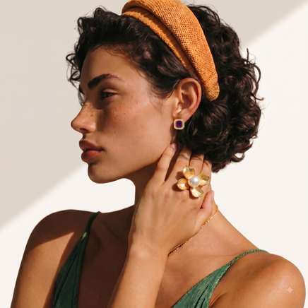 Model wearing oversized gold-tone flower statement ring with central white pearl | Olaty