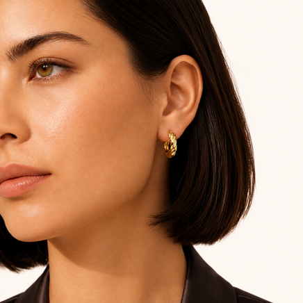 Model wearing Twisted Gold Huggie Hoops in polished 14K gold-plated sterling silver | Olaty