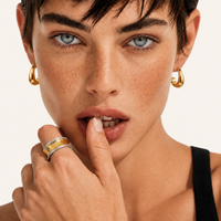 Sculpted Curve Gold Huggie Earrings worn on model close-up | Olaty
