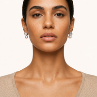 Stardust freshwater pearl drop earrings with geometric crystal settings worn on model | Olaty