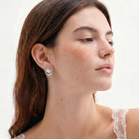 Pearl Orbit stud earring with freshwater pearl and concentric circle design worn on model | Olaty