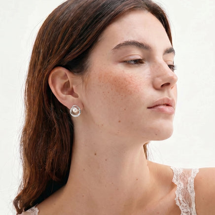 Pearl Orbit stud earring with freshwater pearl and concentric circle design worn on model | Olaty