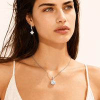 Model wearing GRA Certified Moissanite Diamond Dangle Huggies in polished sterling silver | Olaty