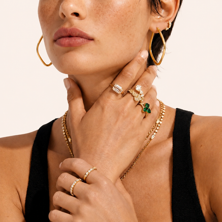 Model wearing large Geometry Class Hoops in polished gold-plated sterling silver | Olaty