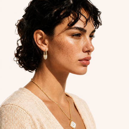 Golden Glow zirconia huggie hoop earring in 14K gold-plated eco-brass styled on model | Olaty