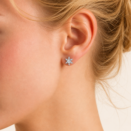 Model wearing Moissanite Diamond Winter Spark Snowflake Stud Earring in polished sterling silver | Olaty