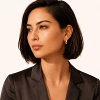 Model wearing Golden Era Huggie Hoops in polished 14K gold-plated sterling silver | Olaty