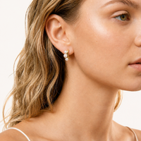 Pearl Trio Curve freshwater pearl stud earring in polished 14K gold-plated eco-brass worn on model | Olaty