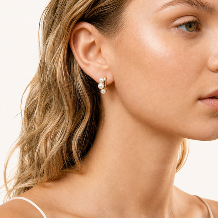 Pearl Trio Curve freshwater pearl stud earring in polished 14K gold-plated eco-brass worn on model | Olaty