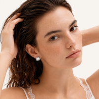 Luminous Pearl Triangle freshwater pearl stud earring styled on model in white gold-plated eco-brass | Olaty