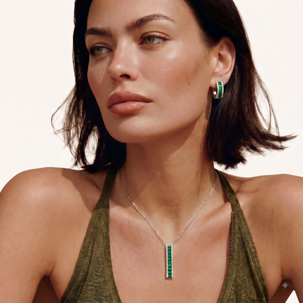 Model wearing emerald green zirconia linear pendant necklace and matching hoop earrings | Olaty