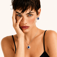 Model wearing sapphire blue halo pendant necklace and matching stud earrings | Olaty