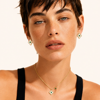 Model wearing Emerald Bloom green zirconia necklace and floral stud earrings | Olaty