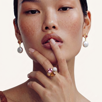 Model wearing sculptural multicolor statement ring with pink crystal, amber stone and pavé sphere | Olaty