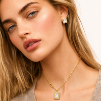 Close-up model wearing emerald cut Zirconia stud earrings and pendant necklace | Olaty