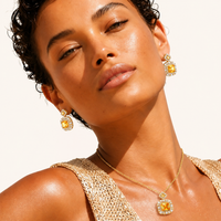 Model wearing golden square Zirconia pendant necklace and matching statement drop earrings | Olaty
