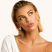 Clover statement hoop earrings with textured finish and sparkling zirconia styled on model | Olaty
