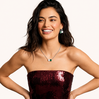 Model wearing emerald green and clear zirconia geometric necklace and matching earrings | Olaty