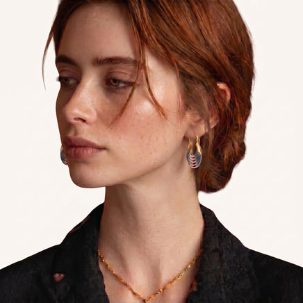 Model wearing blue and pink enamel ripple hoop earrings with sculptural layered design | Olaty