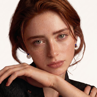 Model wearing Lapis Lazuli and Mother of Pearl stud earrings with layered teardrop design | Olaty