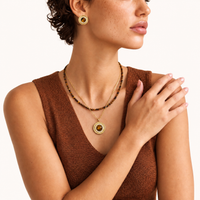 Model wearing tiger eye halo pendant necklace, brown beaded necklace and matching round earrings | Olaty