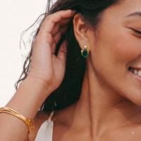 Model wearing emerald Liuli glass stud earring with gold-tone frame and sparkling Zirconia accents | Olaty