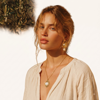 Model styling cosmic mother of pearl orbital pendant necklace with cream blouse | Olaty