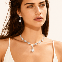 Model wearing Celestial Cascade zirconia Y necklace and matching drop earrings | Olaty
