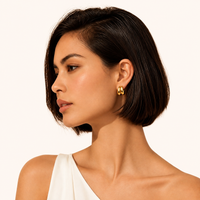 Model wearing polished Liquid Gold Sculptural Hoops in 18K gold-plated sterling silver | Olaty
