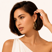 Model styling Geometry Class Hoops with elongated geometric gold silhouette | Olaty