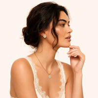 Model styling floral pendant necklace and matching green zirconia stud earrings | Olaty