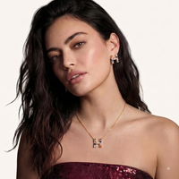 Model wearing colorful zirconia H initial necklace and matching earrings | Olaty