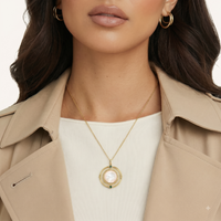 Cosmic mother of pearl orbital pendant necklace worn with neutral layered outfit | Olaty