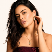 Model wearing crystal teardrop pendant necklace and matching drop earrings | Olaty