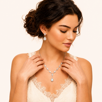 Model styling white gold plated zirconia necklace with matching oval drop earrings | Olaty